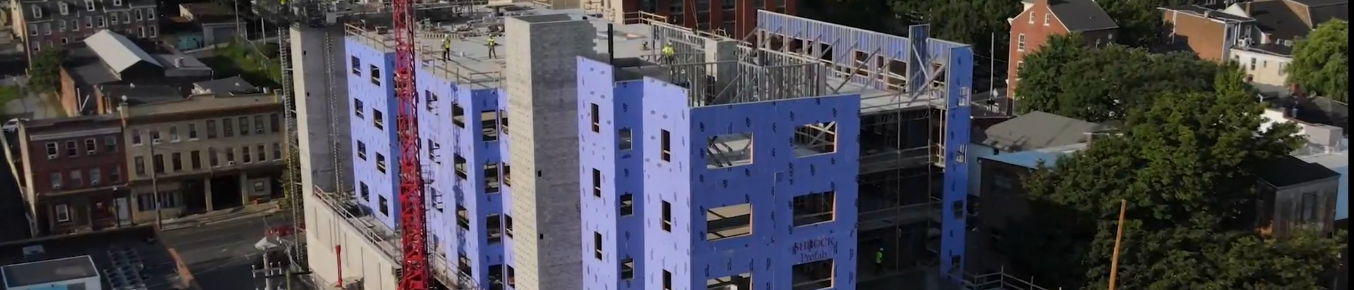 An aerial view of a building under construction in a city.