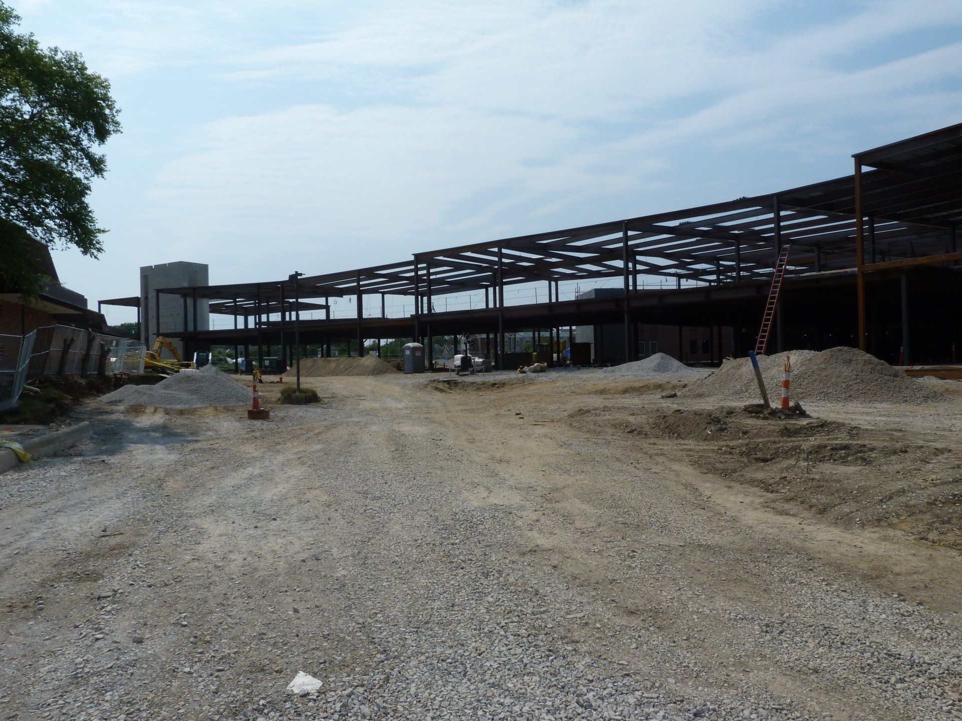 A gravel road leading to a building under construction.