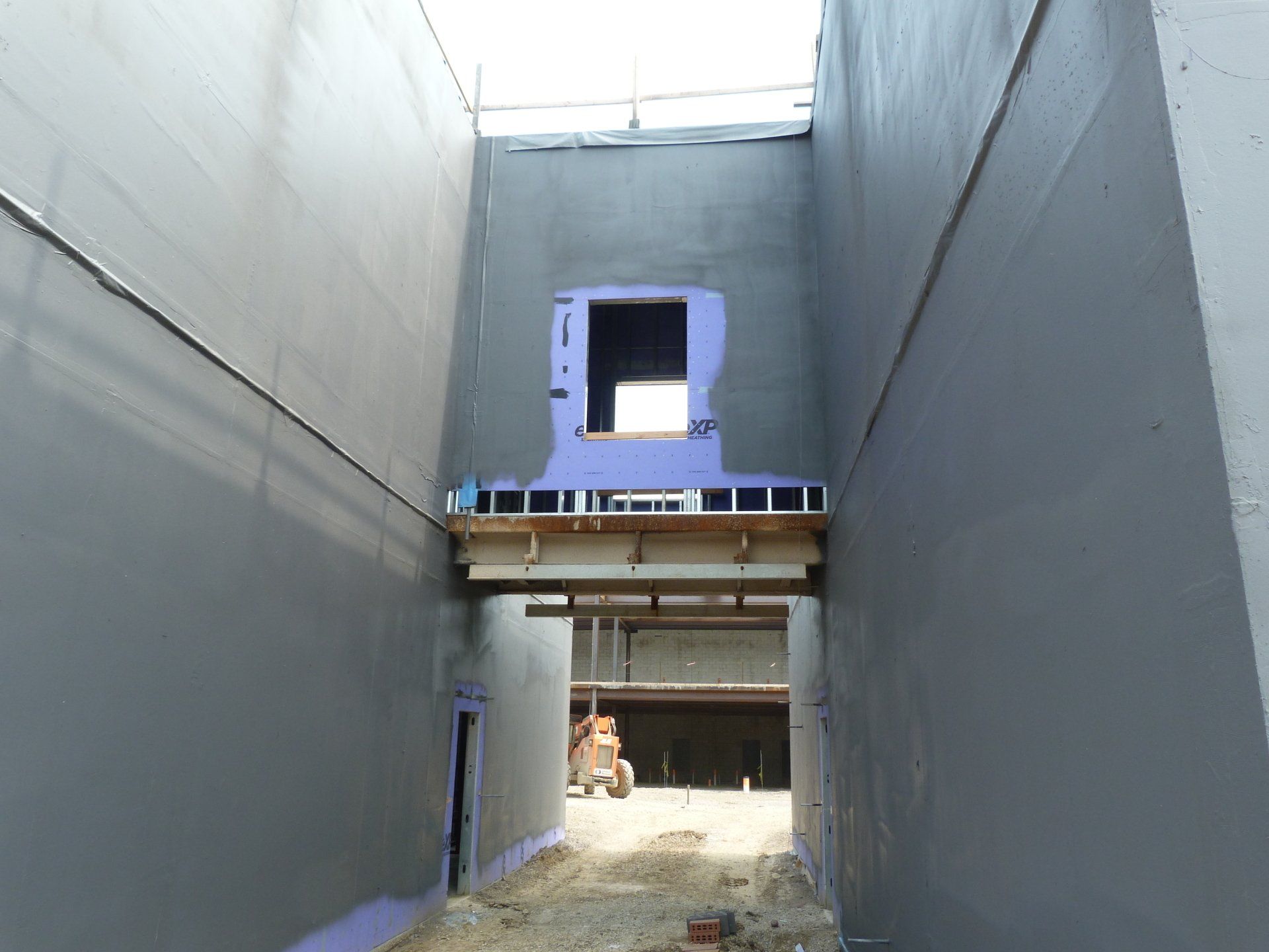 A building under construction with a window in the middle.