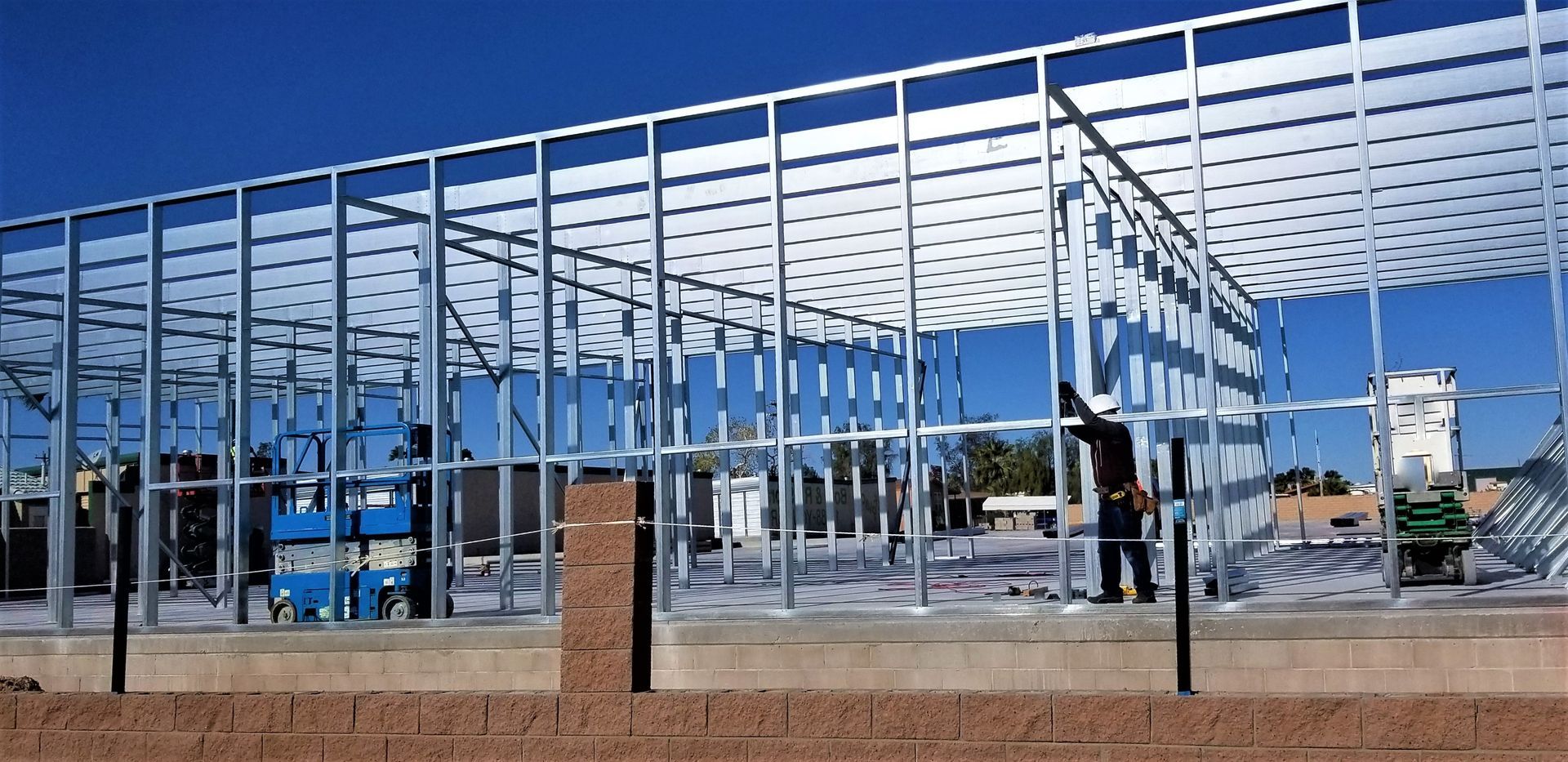 A building under construction with a blue sky in the background.