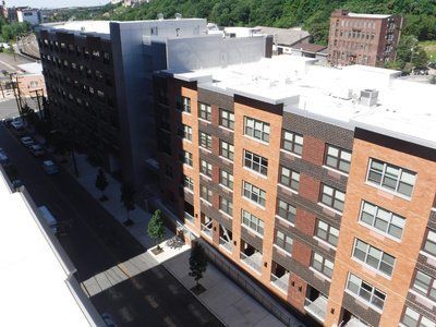 An aerial view of a large apartment building with lots of windows.