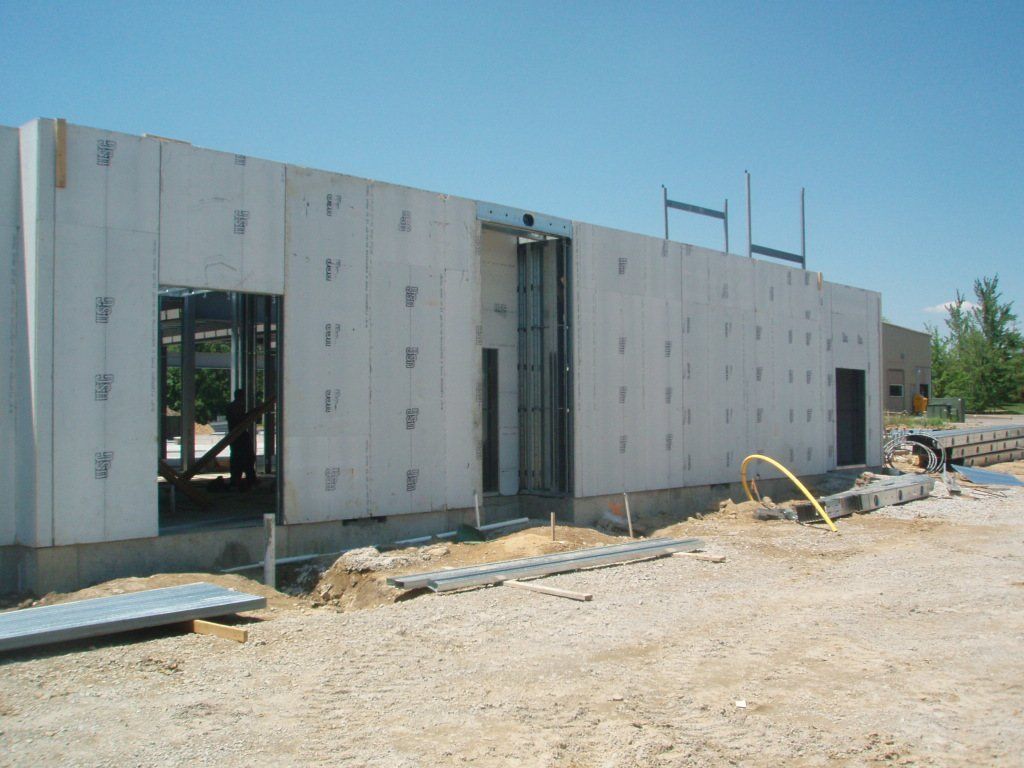 A building under construction with a blue sky in the background.