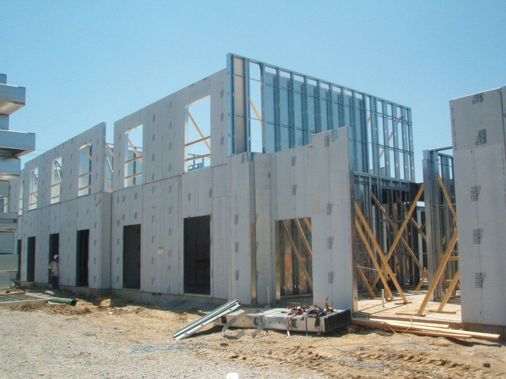 A building under construction with a blue sky in the background.