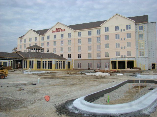 A large building with the words Hilton Garden Inn on it.