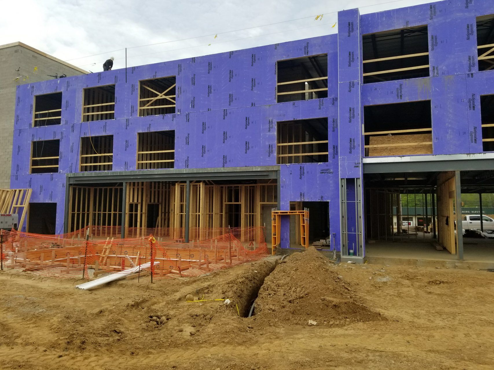 A large building being constructed with a lot of windows throughout.