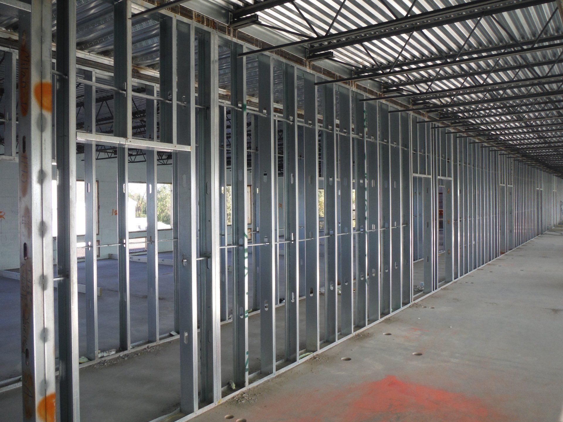 A long hallway with a lot of metal frames on the walls.