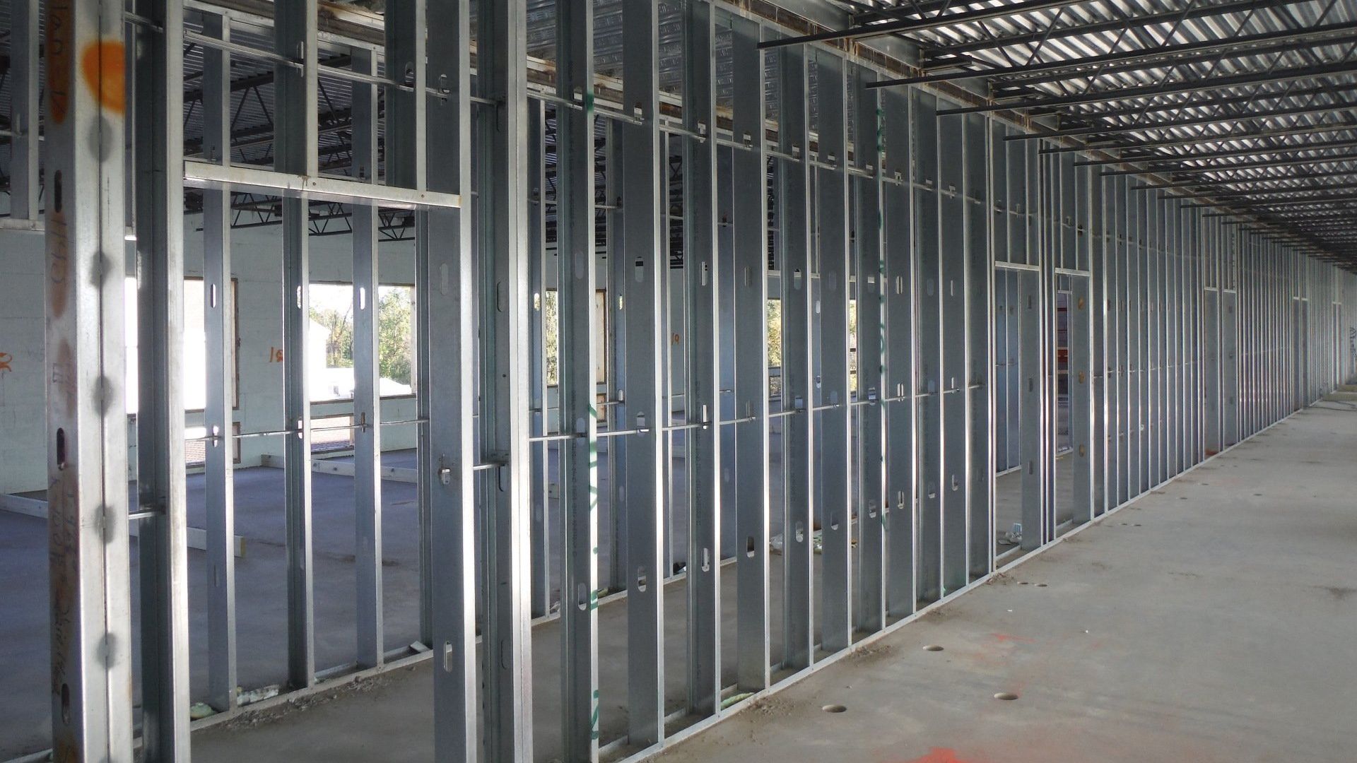 A long hallway with a lot of metal frames in a building under construction.