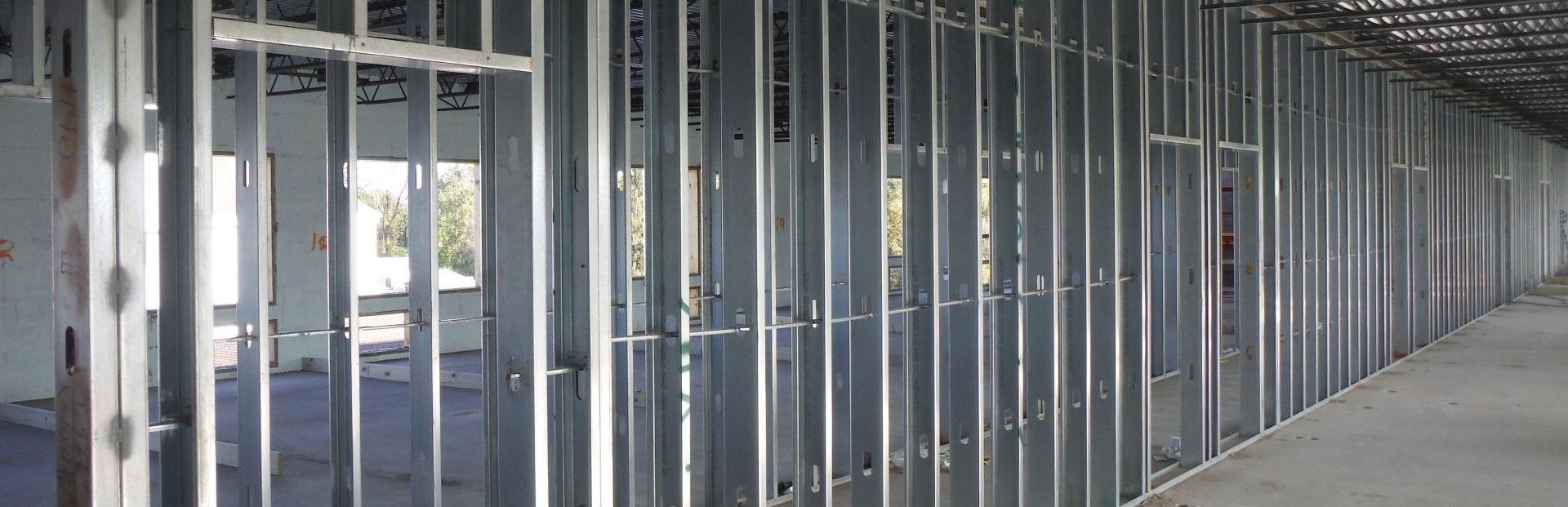A long hallway with a lot of metal walls in a building under construction.