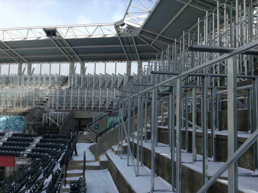 A stadium under construction with a lot of metal scaffolding.