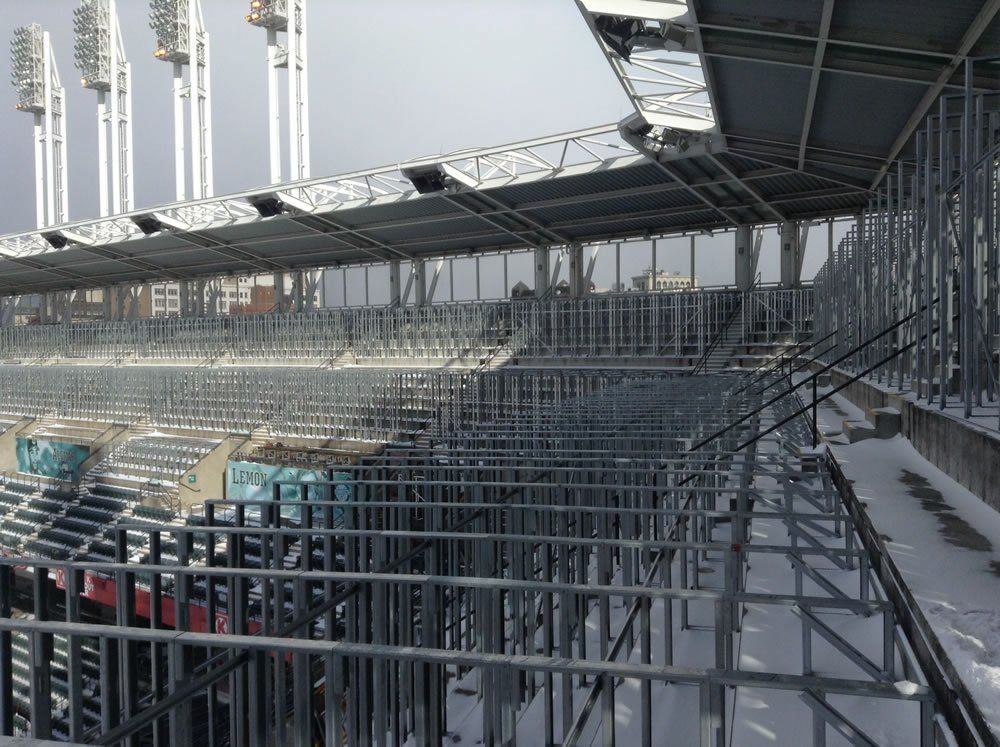 A stadium with empty seats and stairs in the snow.
