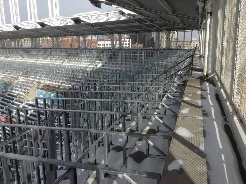 A stadium with a lot of empty seats under construction.