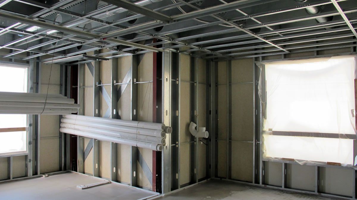 A room under construction with a ceiling and walls.