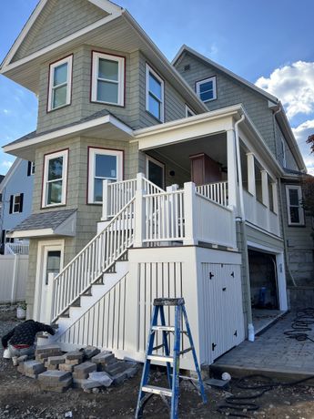 A house with stairs and a ladder in front of it
