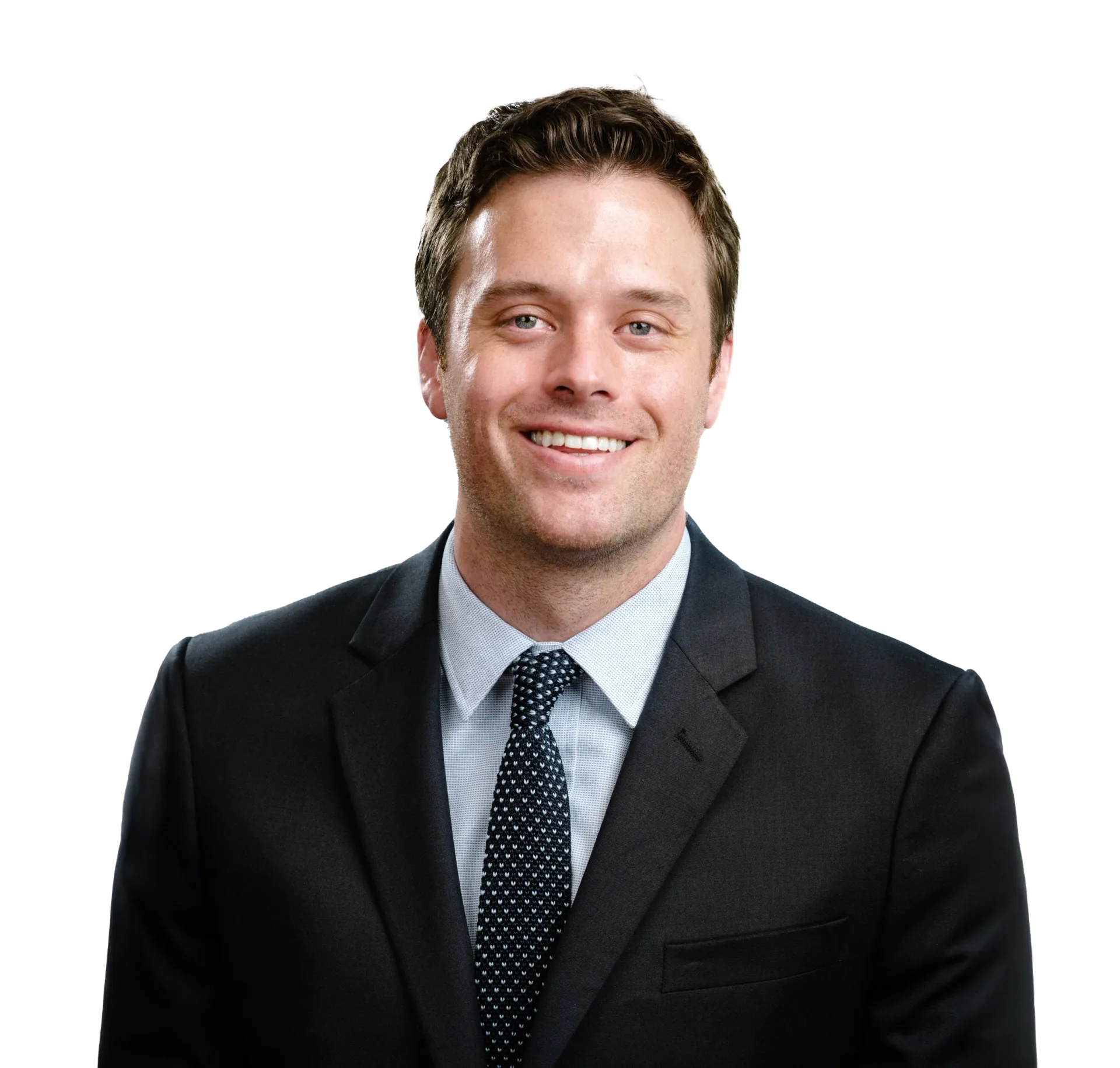 Smiling man in a dark suit and tie against a white background