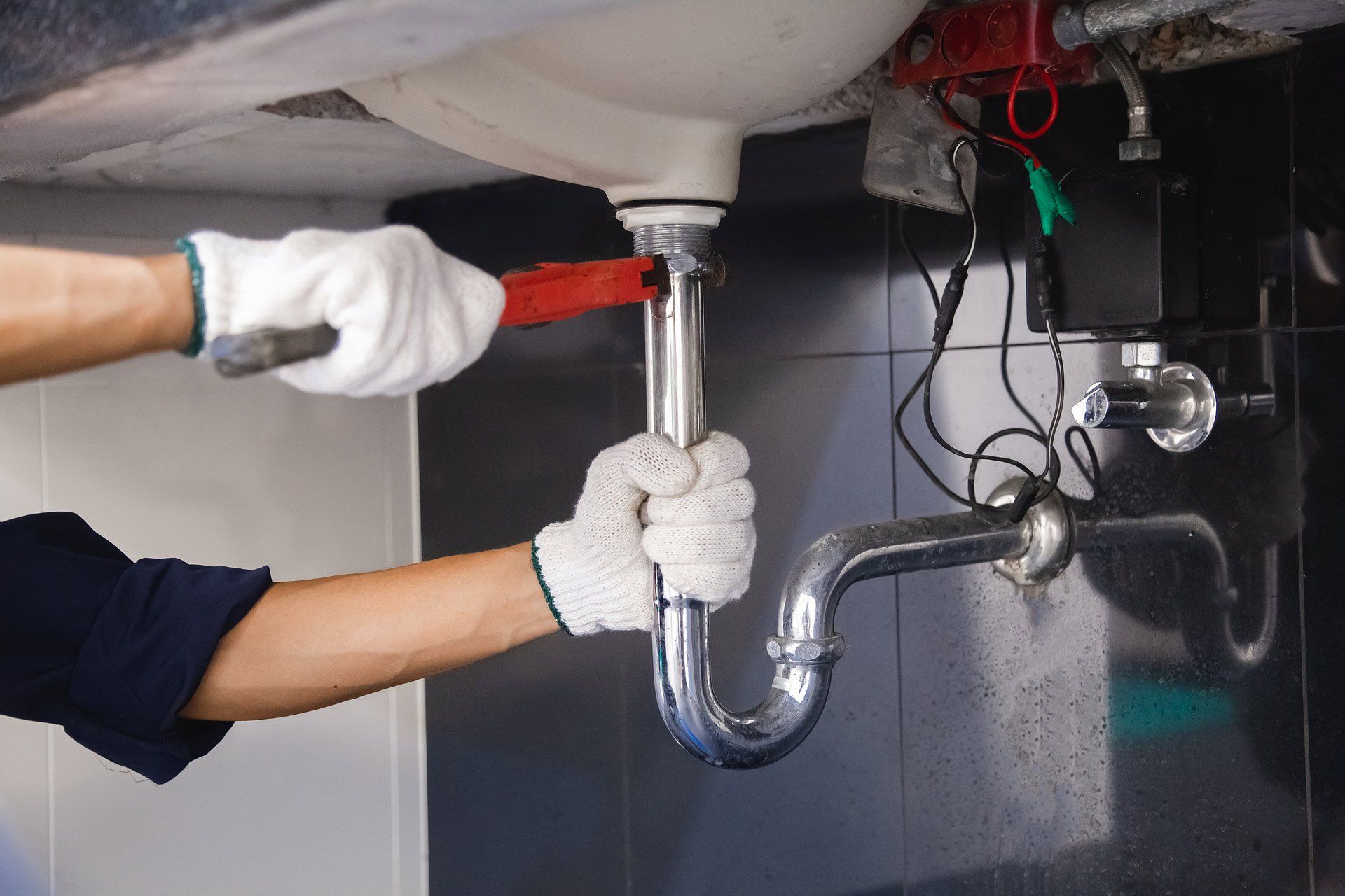 Plumber Fixing White Sink Pipe With Adjustable Wrench | Ashfield, Nsw | Aussie Bathrooms
