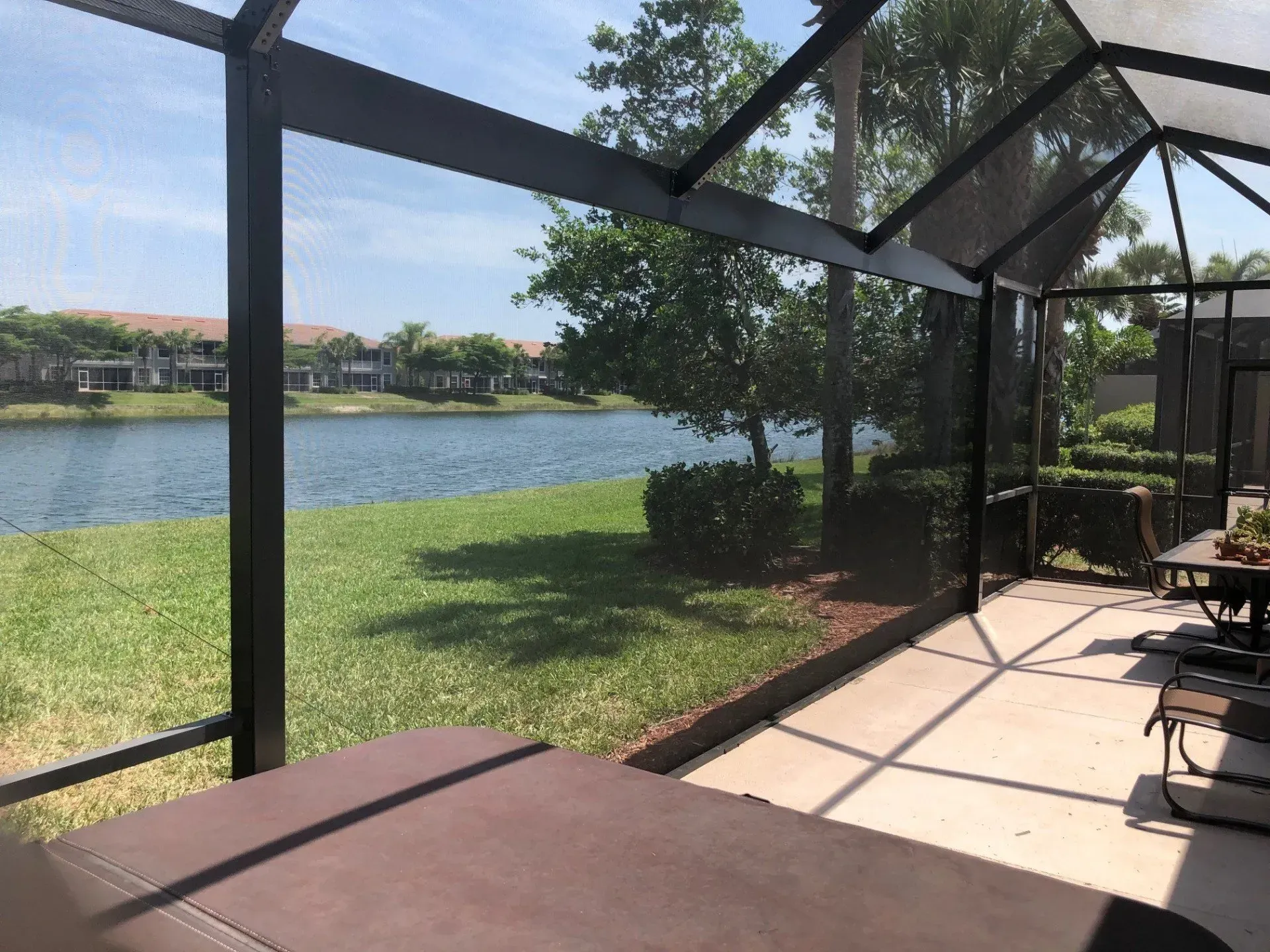 A screened in patio with a view of a lake