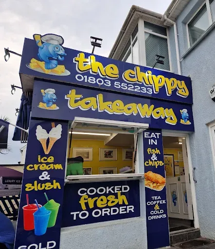 The Chippy takeaway storefront with blue and yellow signage, offering ice cream, slush, and cooked-to-order fish and chips.