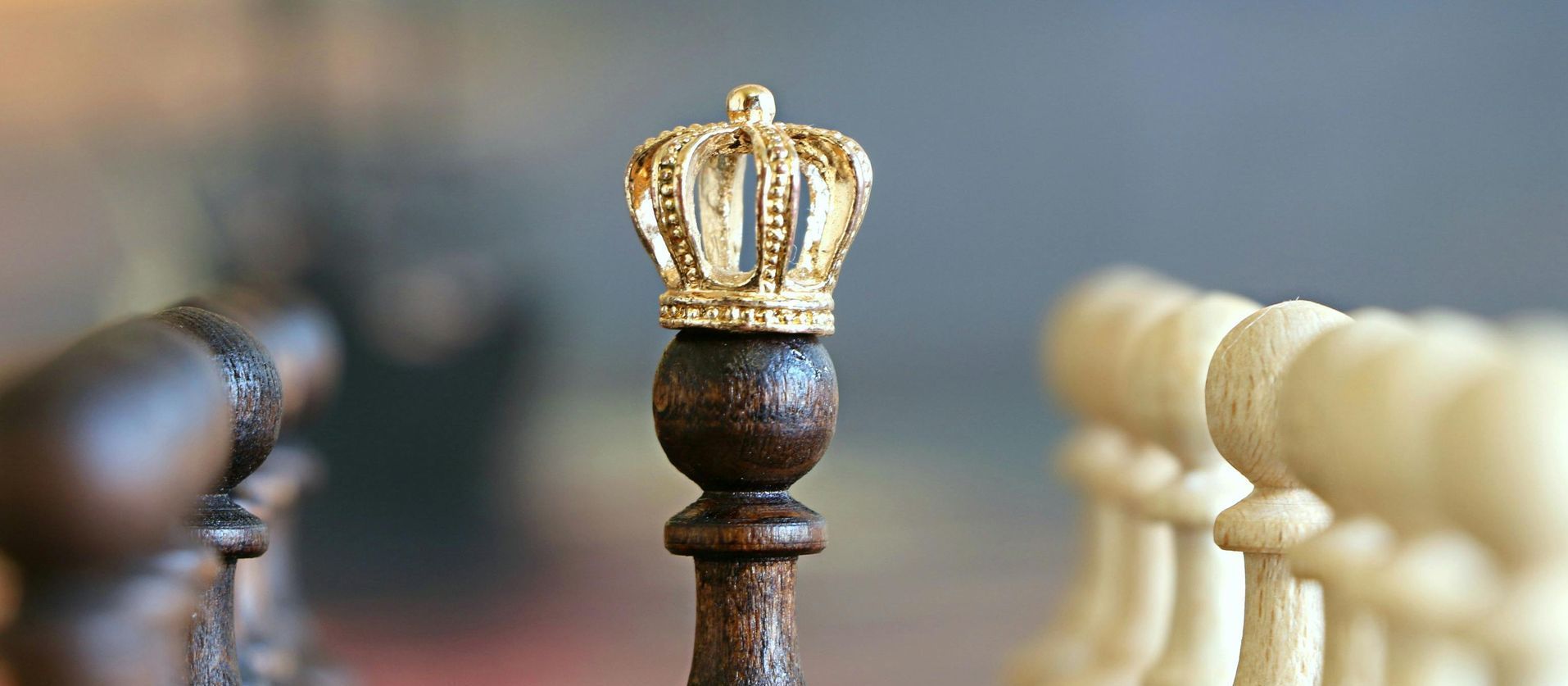 A close up of a chess piece with a crown on top of it.