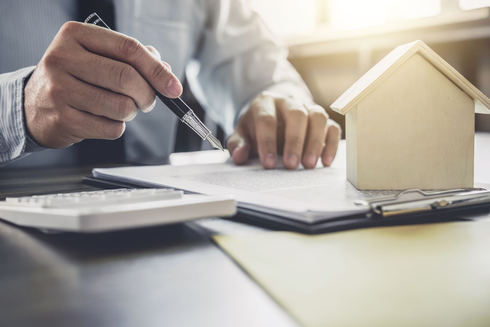 Person with a pen writing