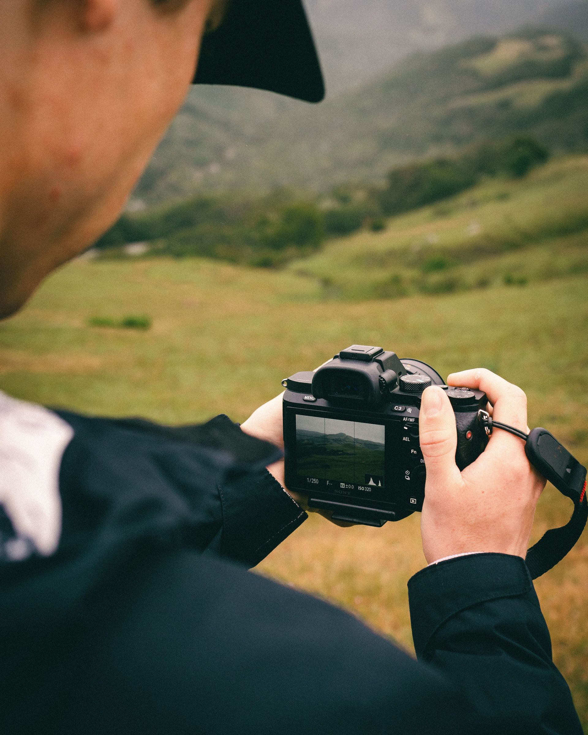 Man taking a photo in the mountains
