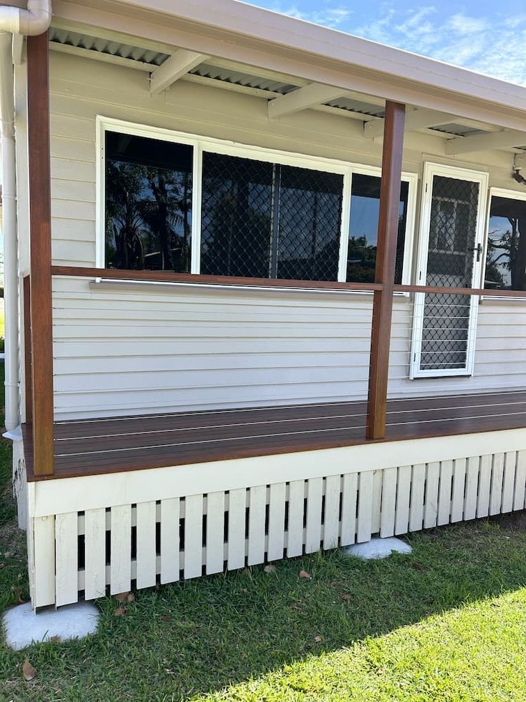 A house with a porch and a fence in front of it — Building Services in Rockhampton