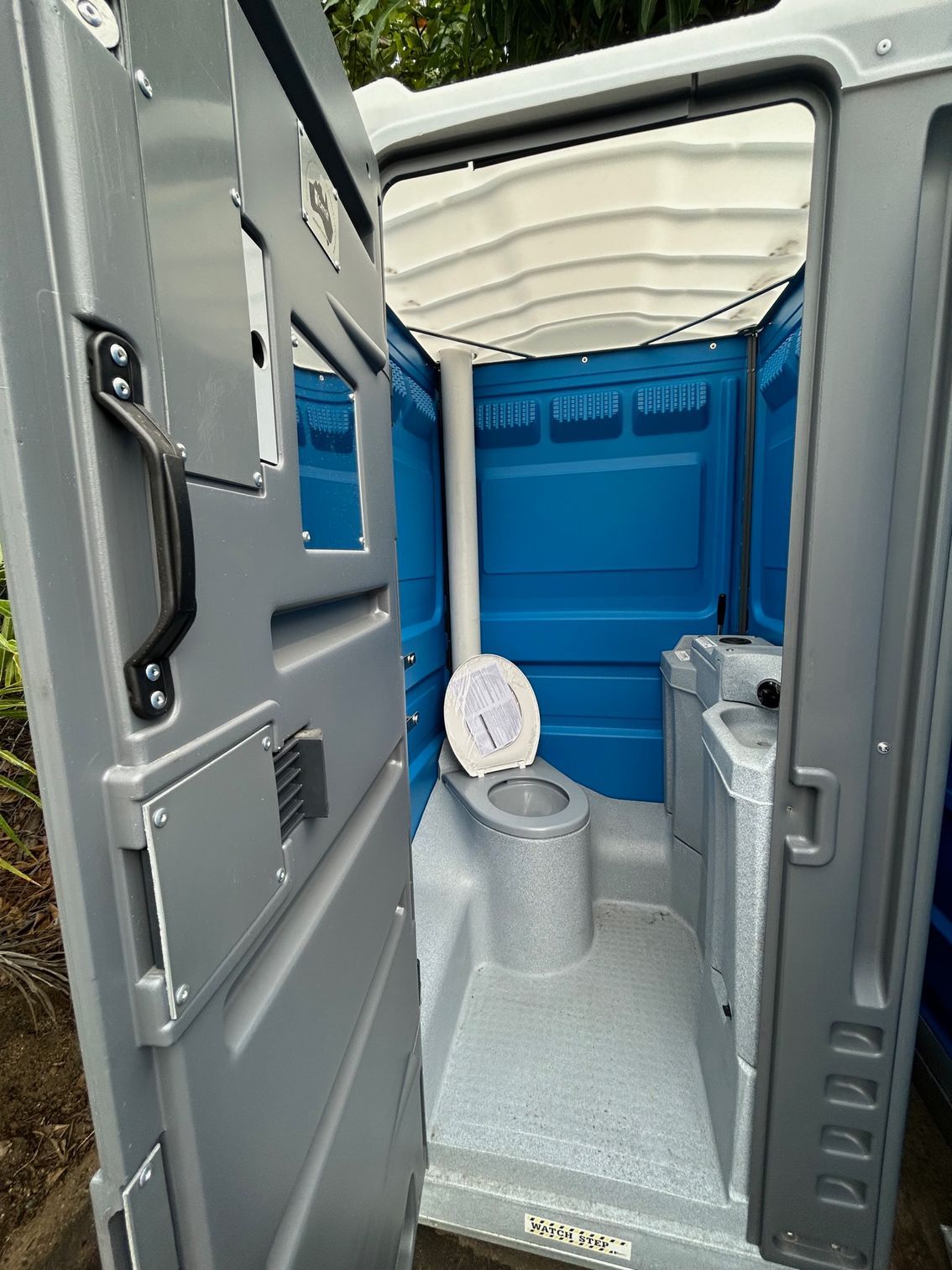 A Blue and Gray Portable Toilet is on a Trailer — Proserpine Septic Service In Airlie Beach, QLD