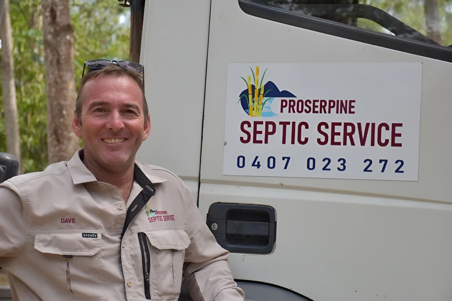 A Man Leaning on a Septic Tank Truck — Proserpine Septic Service In Cannonvale, QLD
