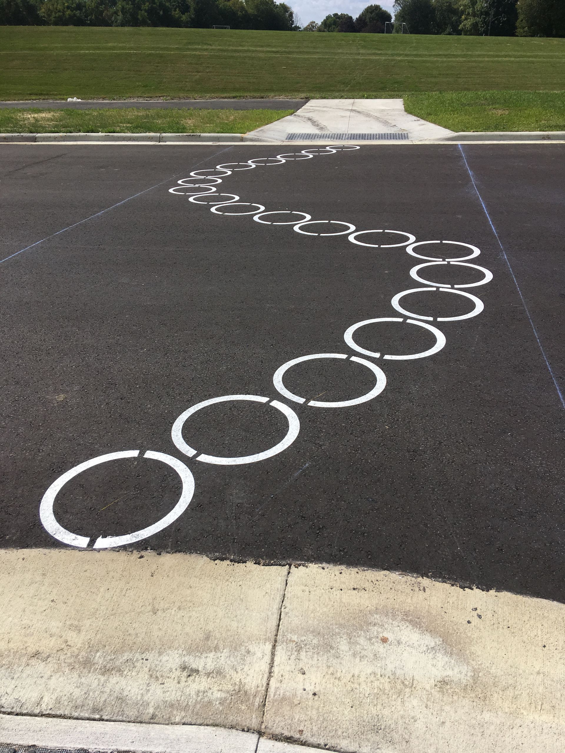 A Black Road with White Circles Painted on It | Owatonna, MN | Seykora Striping