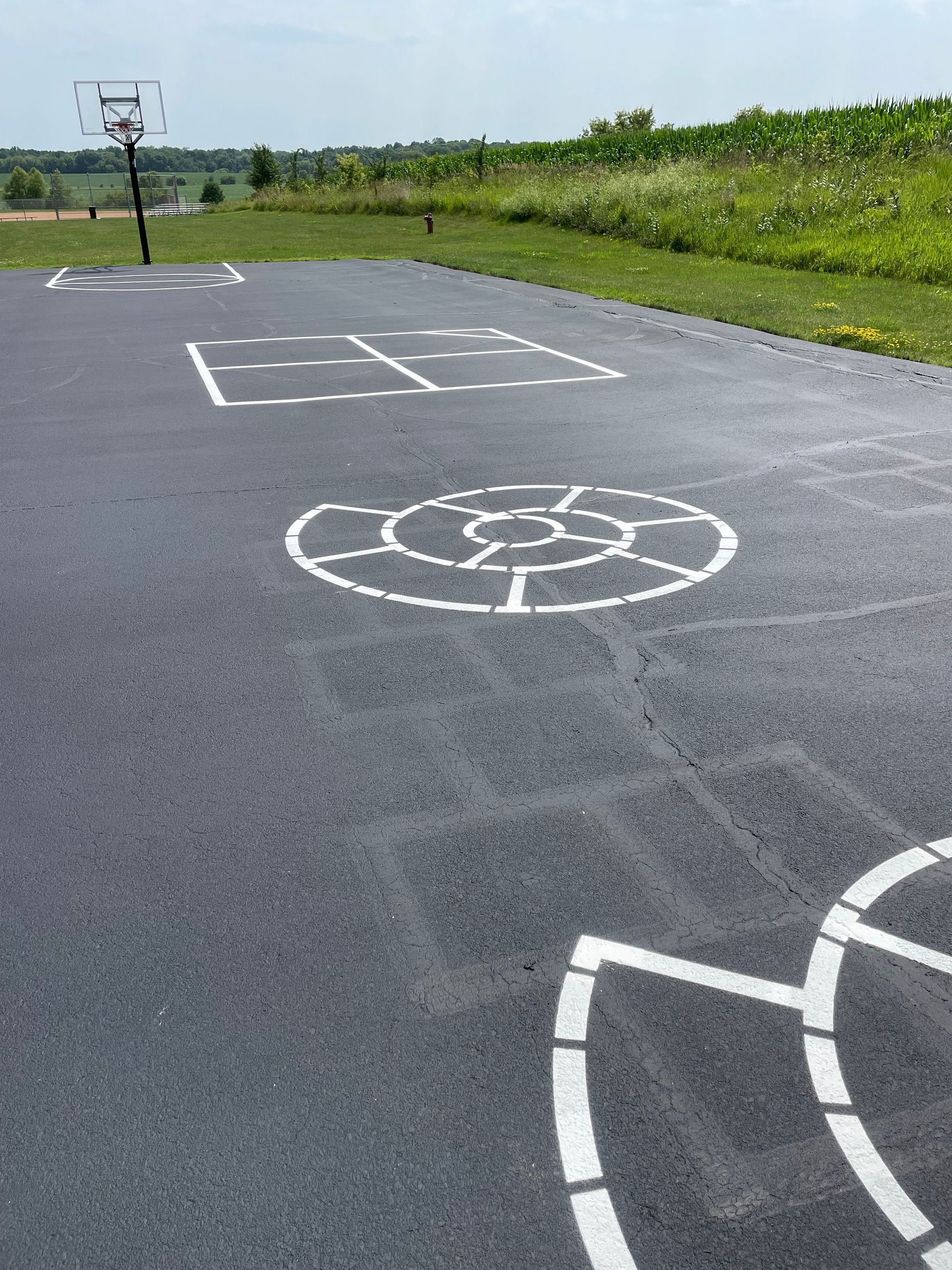 A Basketball Hoop Is on The Side of The Road | Owatonna, MN | Seykora Striping