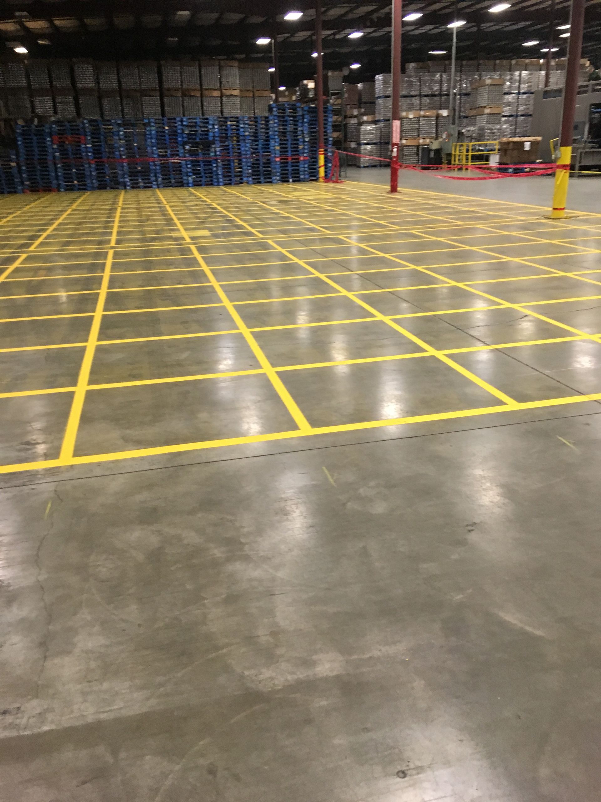 A Large Warehouse with Yellow Lines on The Floor | Owatonna, MN | Seykora Striping