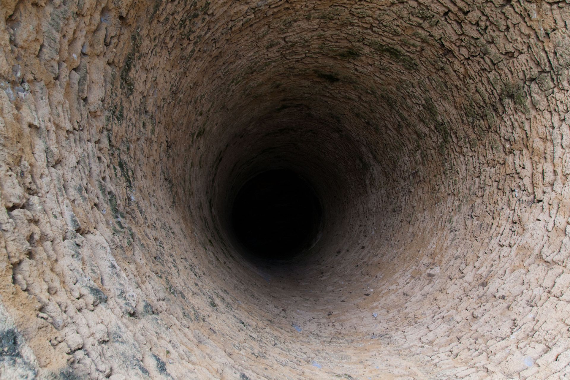 Old, deep and dry well.