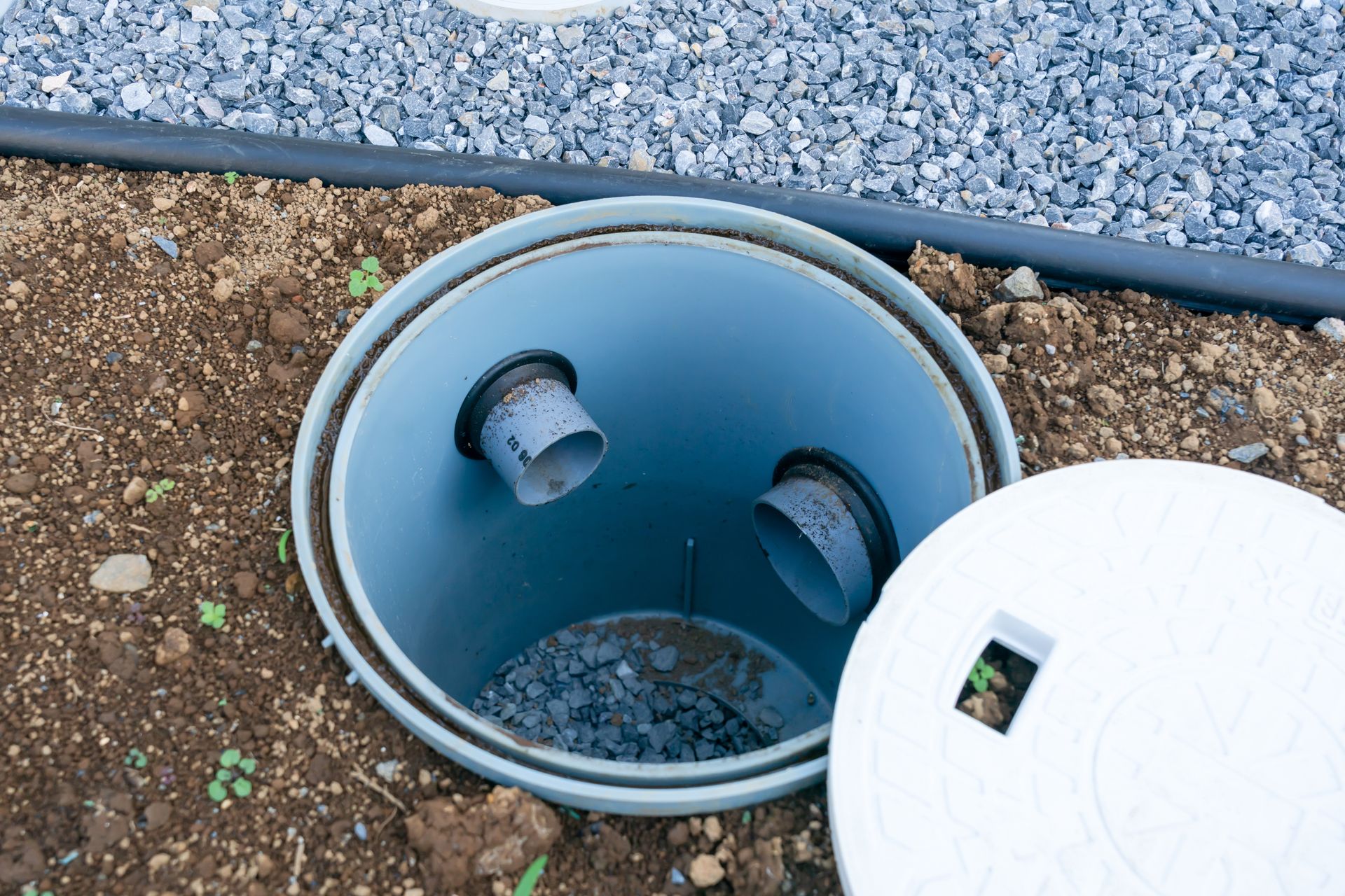 Drywell repairing cracked chamber with sediment and water backup.