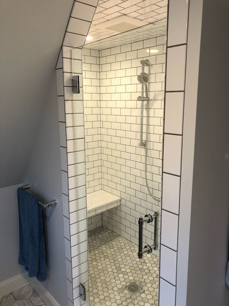 A bathroom with a toilet a sink and a shower