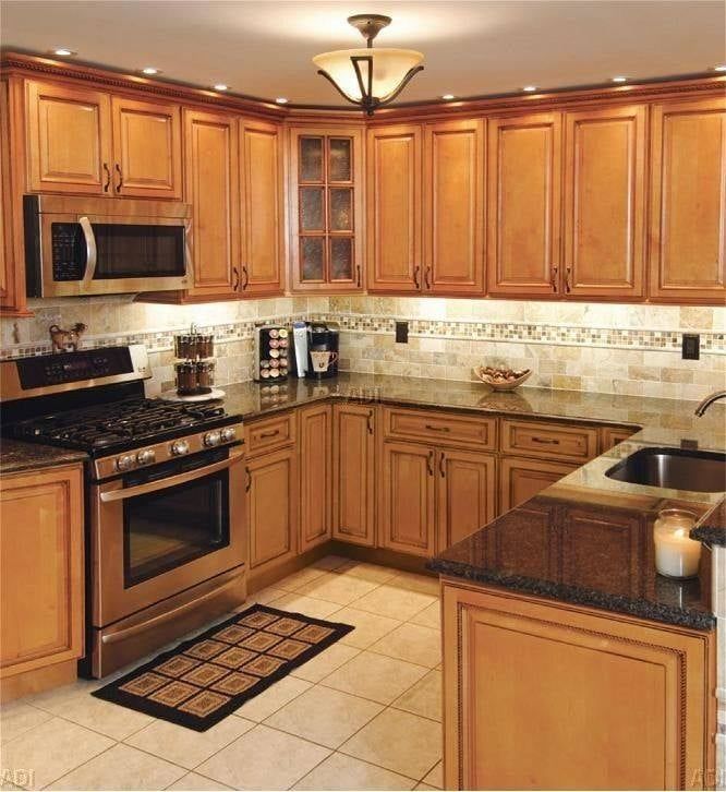 A kitchen with wooden cabinets and stainless steel appliances