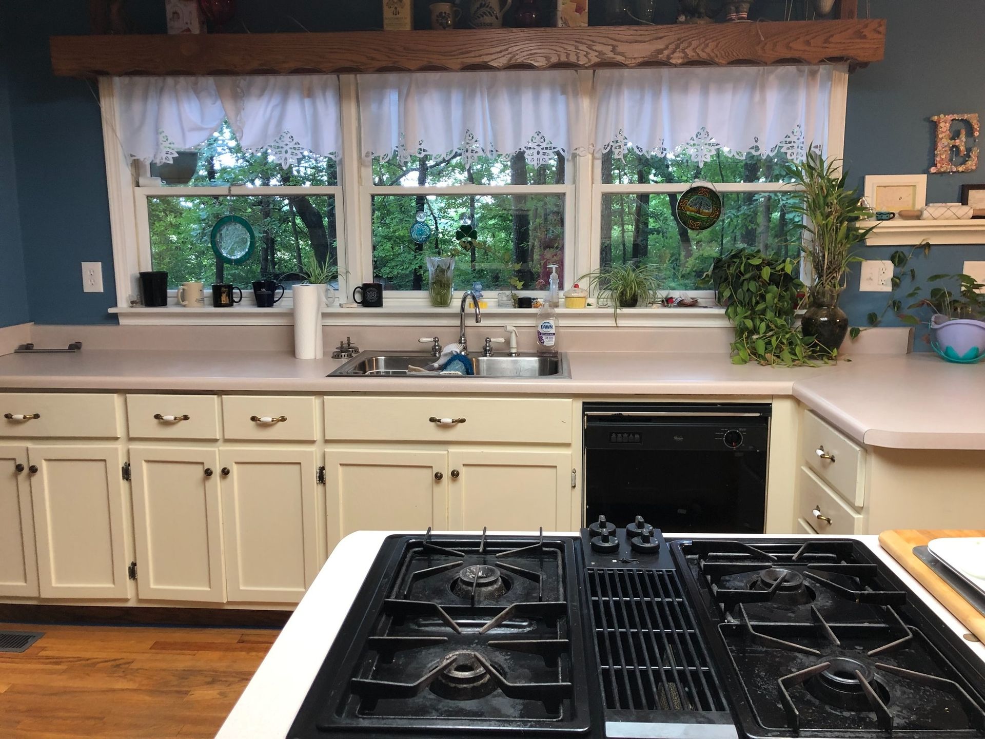 A kitchen with a stove top oven and a sink