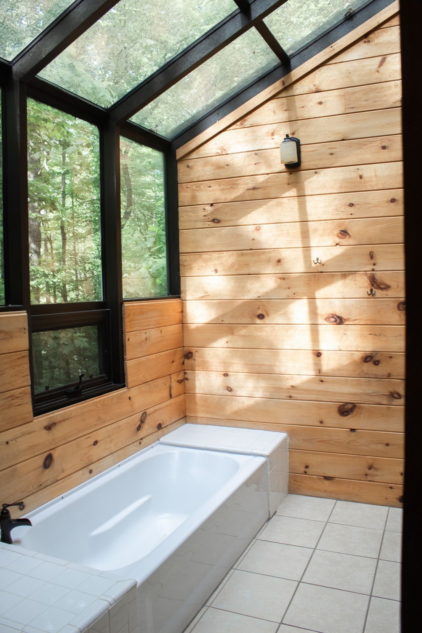 A bathroom with a bathtub and a glass roof