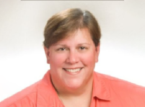 Smiling person in a coral shirt against a plain white background