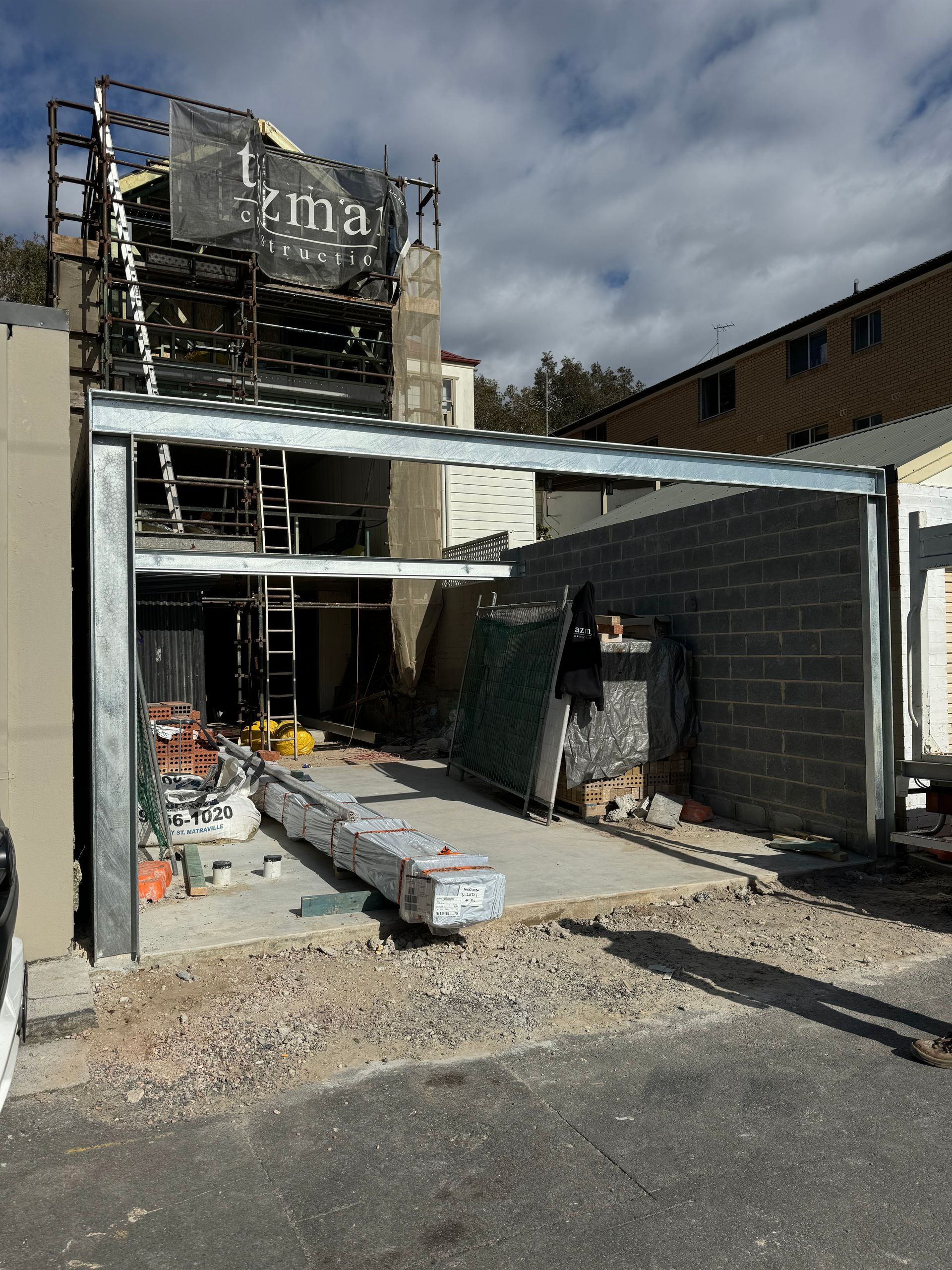 A building under construction with a sign that says prima on it