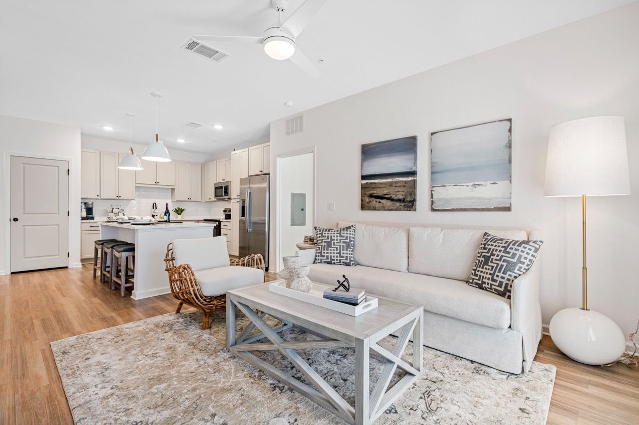 Open-concept living area with a gray sofa, coffee table, and kitchen island.