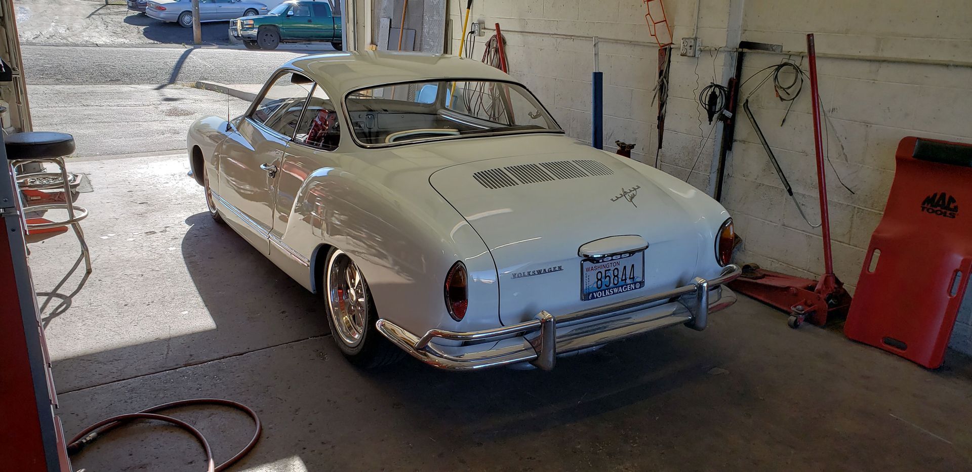 A white car is parked in a garage.