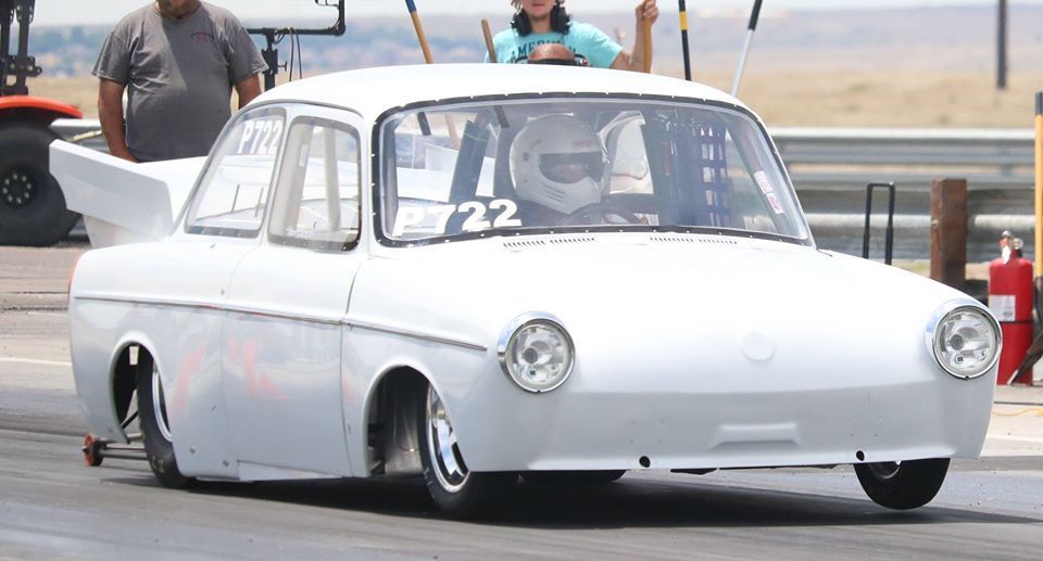 A white car with the number 22 on the windshield