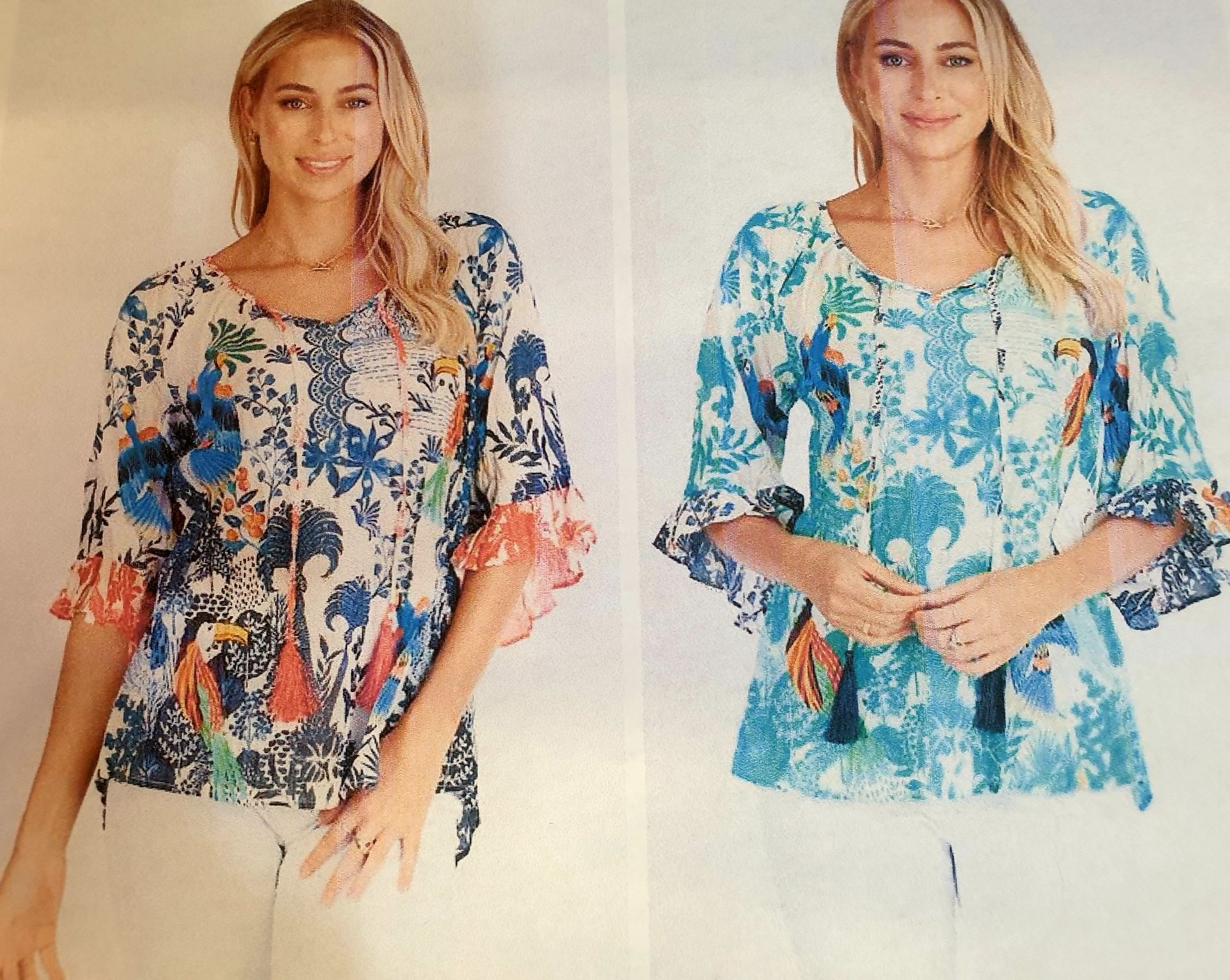 Two women wearing patterned blouses, one in blue and the other in turquoise, both smiling.