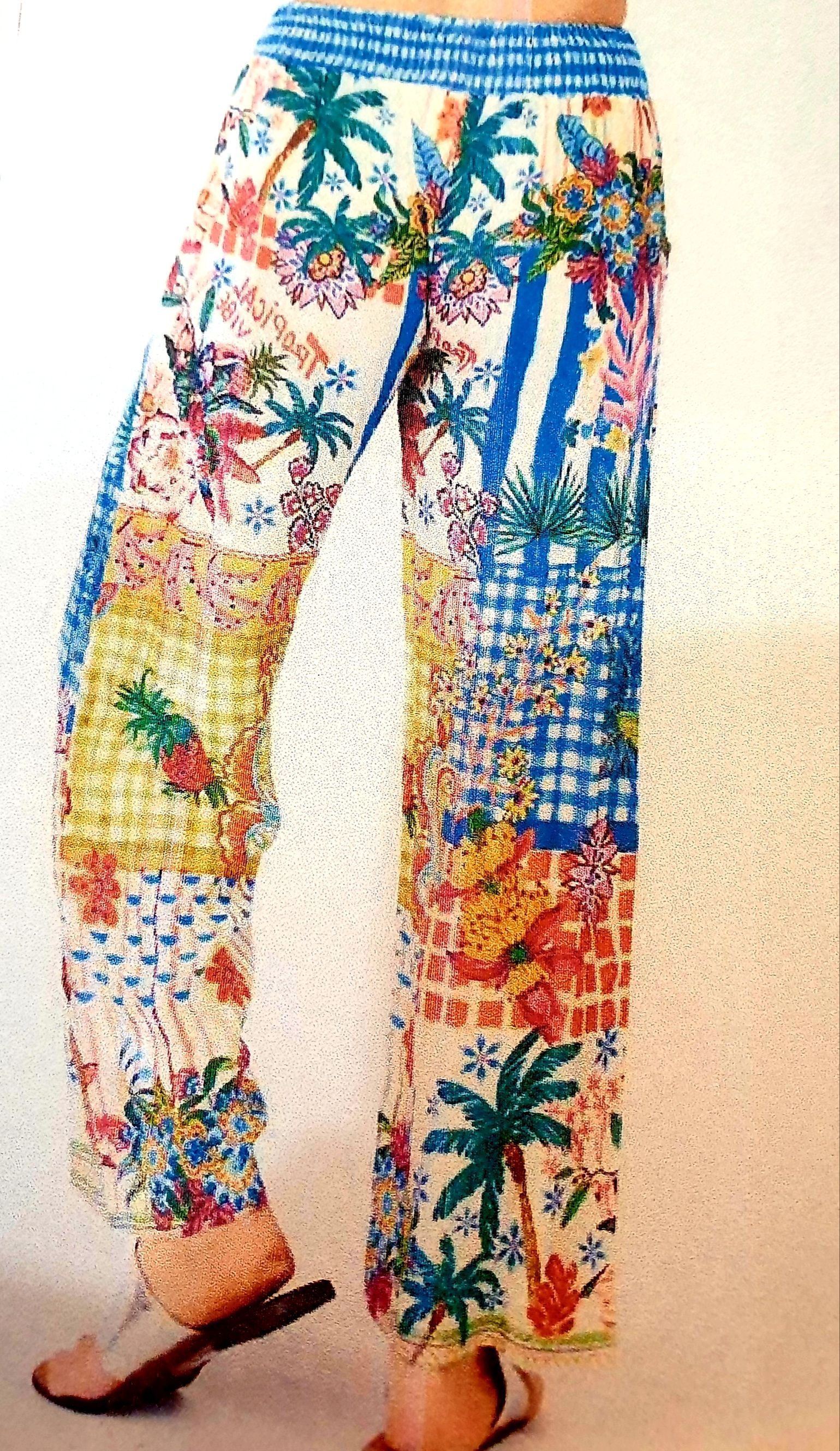 Multi-colored, patterned pants with tropical palm trees and a blue waistband.