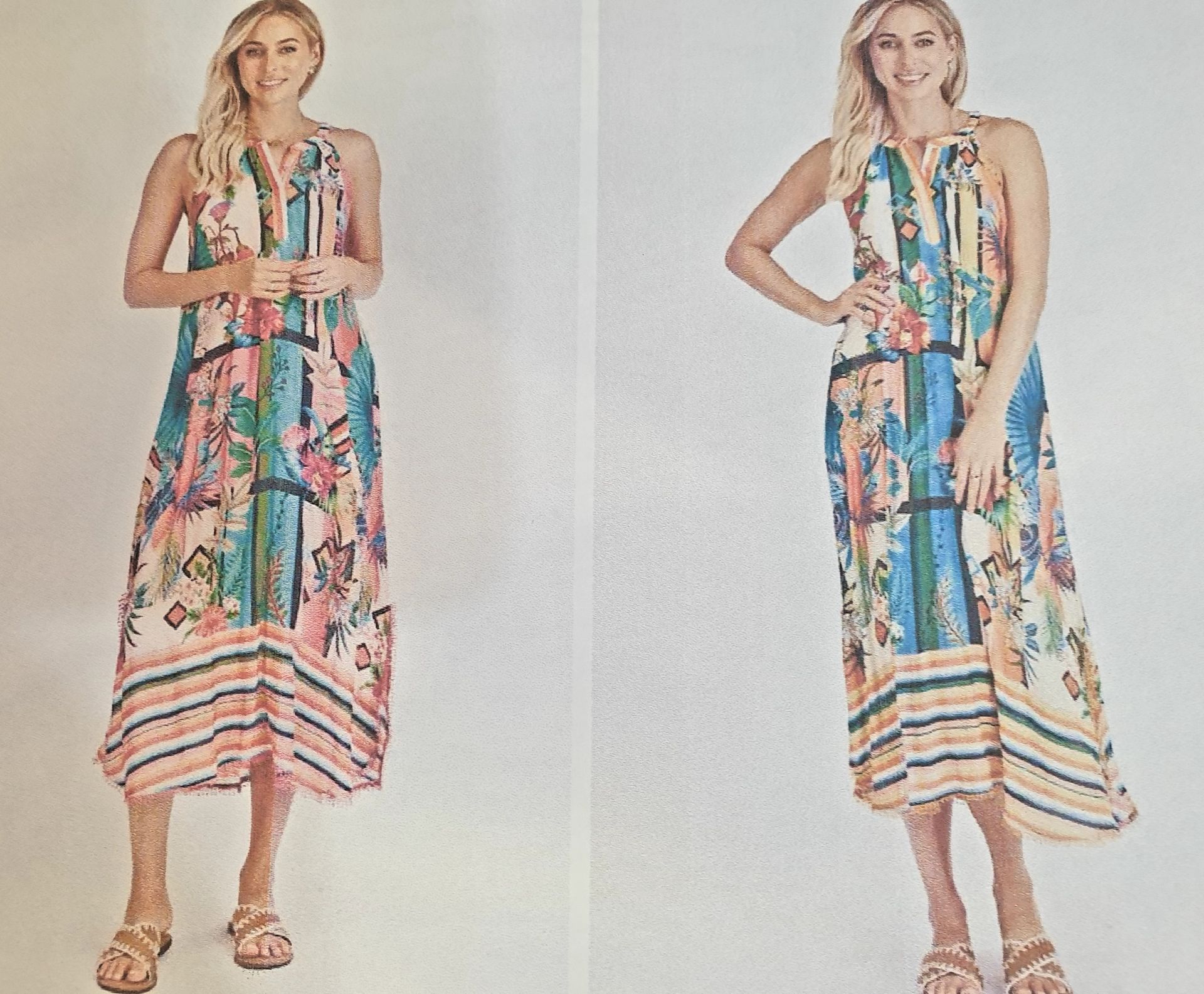 Woman in colorful patterned maxi dress, standing with sandals, smiling.