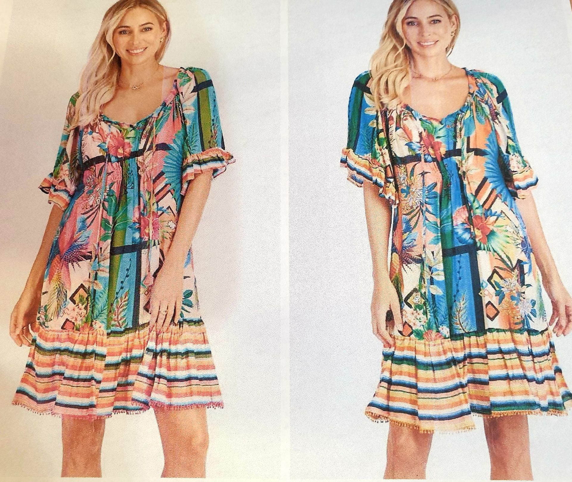 Two women in tropical print dresses with ruffle hem, smiling.