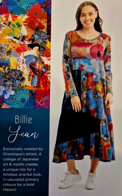 Woman in colorful dress with Japanese art print; white sneakers.