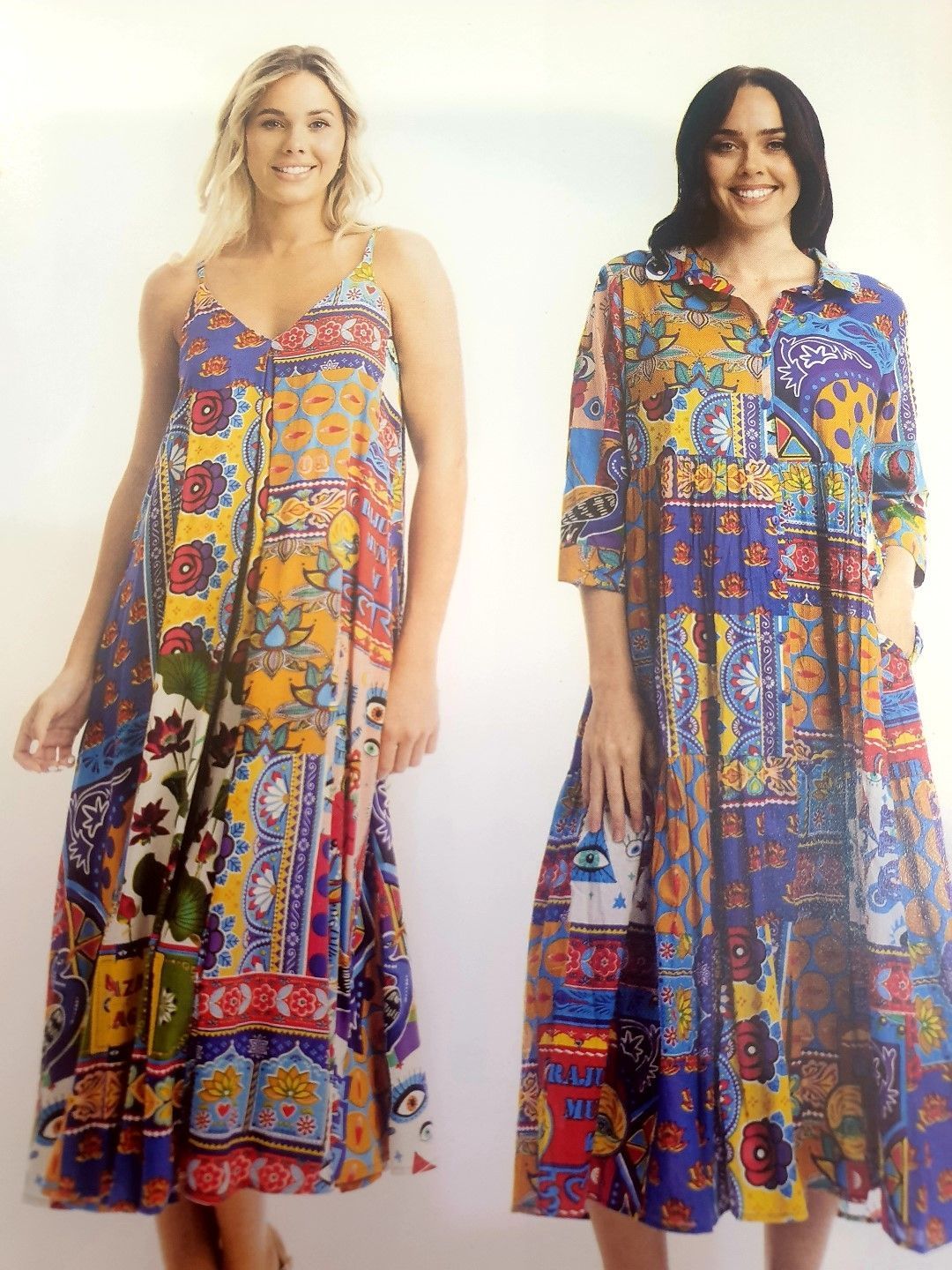 Two women in colorful patterned dresses smiling.