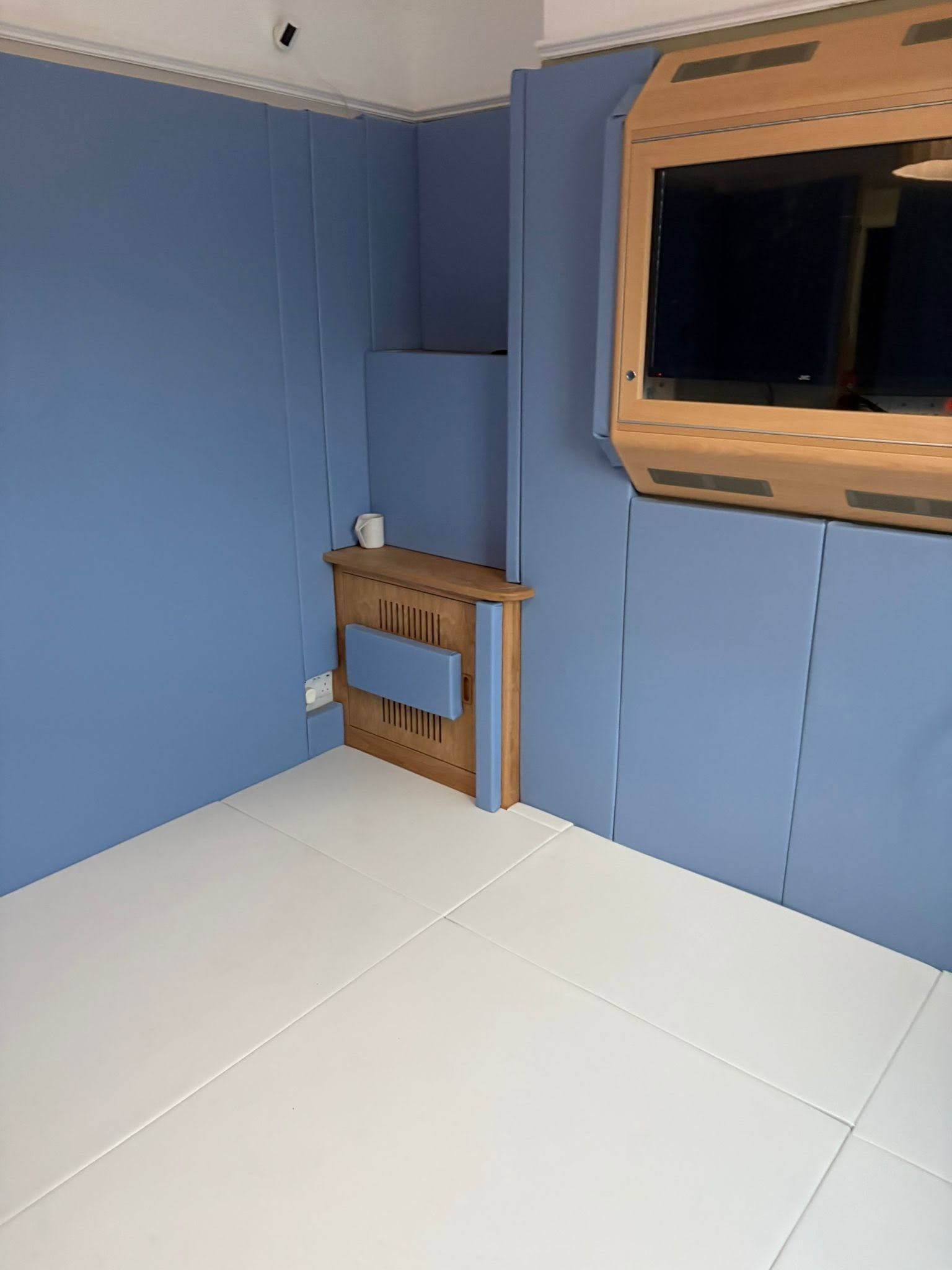Padded room with protected tv unit and padded radiator 