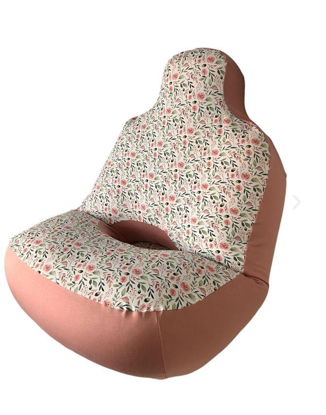 A pink snoezi chair with a floral pattern on it
