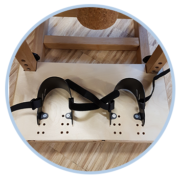 A wooden table with straps attached to it